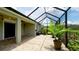 Screened-in patio with tile flooring, fan, lighting and a view of the backyard at 7364 47Th Avenue E Cir, Bradenton, FL 34203