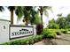 Community signage for Stoneledge, framed by lush landscaping featuring palm trees and manicured hedges at 7364 47Th Avenue E Cir, Bradenton, FL 34203