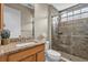 Bathroom with glass shower, granite counters, neutral wall color and decorative sprigs at 7628 Haddington Cv, Lakewood Ranch, FL 34202
