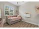 Bright bedroom featuring a daybed, wood floors, large window and built-in shelving at 7628 Haddington Cv, Lakewood Ranch, FL 34202