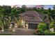 Beautiful home with a well-manicured lawn, tile roof, and mature landscaping at 7628 Haddington Cv, Lakewood Ranch, FL 34202
