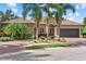 Beautiful home with tile roof, lush landscaping, brick driveway and two-car garage at 7628 Haddington Cv, Lakewood Ranch, FL 34202