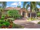Charming home with tile roof, lush landscaping, brick driveway and two-car garage at 7628 Haddington Cv, Lakewood Ranch, FL 34202