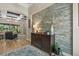Inviting foyer with a decorative stone wall, hardwood floors, and elegant furnishings at 7628 Haddington Cv, Lakewood Ranch, FL 34202