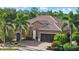 A beautiful home with a terracotta roof, manicured landscaping, and a paver driveway at 7628 Haddington Cv, Lakewood Ranch, FL 34202