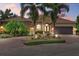 Charming single-Gathering home featuring a tile roof, paved driveway, and lush tropical landscaping at 7628 Haddington Cv, Lakewood Ranch, FL 34202