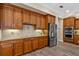 Gourmet kitchen featuring stainless steel appliances, wood cabinets, and granite countertops at 7628 Haddington Cv, Lakewood Ranch, FL 34202
