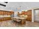 Gourmet kitchen with large island, pendant lighting, stainless appliances, and ample cabinet space at 7628 Haddington Cv, Lakewood Ranch, FL 34202