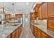 Spacious kitchen with a large island, granite countertops, stainless steel appliances, and custom cabinetry at 7628 Haddington Cv, Lakewood Ranch, FL 34202