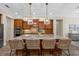 Stylish kitchen island with granite countertops, seating, and pendant lighting at 7628 Haddington Cv, Lakewood Ranch, FL 34202