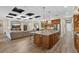 Spacious kitchen with a large island, pendant lighting, and stainless steel appliances at 7628 Haddington Cv, Lakewood Ranch, FL 34202