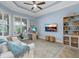 Cozy living room featuring blue walls, a white sofa, and a built in bookcase at 7628 Haddington Cv, Lakewood Ranch, FL 34202
