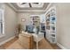 Cozy home office with custom built-in shelving and a bright workspace at 7628 Haddington Cv, Lakewood Ranch, FL 34202