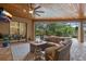 Cozy outdoor patio with a fire pit, comfortable seating, and view of the pool at 7628 Haddington Cv, Lakewood Ranch, FL 34202