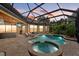 Relaxing screened pool and spa area with outdoor lounge and television creates an oasis for entertaining at 7628 Haddington Cv, Lakewood Ranch, FL 34202