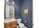 Chic powder room with blue textured wallpaper and a vintage-inspired vanity at 8209 Redonda Loop, Lakewood Ranch, FL 34202