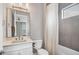 Well-lit bathroom with a modern vanity, shower with gray tile, and a toilet at 8209 Redonda Loop, Lakewood Ranch, FL 34202