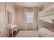 Charming pink ' room featuring a bunk bed, desk area, and soft carpet for a cozy atmosphere at 8209 Redonda Loop, Lakewood Ranch, FL 34202