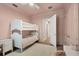 Comfortable ' room features a bunk bed, a desk, and a soft rug on top of hardwood floors at 8209 Redonda Loop, Lakewood Ranch, FL 34202