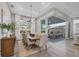 Elegant dining room with large windows and sliding glass doors to the outdoor kitchen at 8209 Redonda Loop, Lakewood Ranch, FL 34202