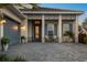 Close-up view of the home's entry and garage, with stylish architectural details and brick-paved driveway at 8209 Redonda Loop, Lakewood Ranch, FL 34202