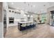 Modern kitchen with a large kitchen island, barstool seating, and stainless steel appliances at 8209 Redonda Loop, Lakewood Ranch, FL 34202