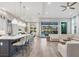 Open-concept living space with island kitchen, and patio doors to the outdoor pool area at 8209 Redonda Loop, Lakewood Ranch, FL 34202