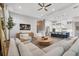 Large living room featuring modern furniture, a fireplace, and an open floor plan to the kitchen at 8209 Redonda Loop, Lakewood Ranch, FL 34202