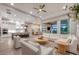 Bright and spacious living room open to the kitchen with stylish furnishings and access to outdoor area at 8209 Redonda Loop, Lakewood Ranch, FL 34202
