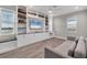 Cozy living room with a built-in entertainment center, a comfortable couch, and a window seat at 8209 Redonda Loop, Lakewood Ranch, FL 34202
