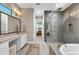Well-appointed main bathroom with dual vanities, walk-in shower, and a large soaking tub at 8209 Redonda Loop, Lakewood Ranch, FL 34202