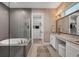 Luxurious main bathroom with a soaking tub and a separate vanity area with great storage at 8209 Redonda Loop, Lakewood Ranch, FL 34202