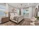 Main bedroom features a decorative chandelier and an area rug that complements the neutral tones at 8209 Redonda Loop, Lakewood Ranch, FL 34202