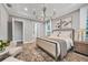 Well-lit main bedroom shows plush bedding, stylish decor, and ample natural light at 8209 Redonda Loop, Lakewood Ranch, FL 34202