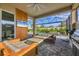 Enjoy the outdoors with this screened-in patio, featuring a built-in grill, television, and comfortable seating at 8209 Redonda Loop, Lakewood Ranch, FL 34202