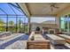 Relax on this screened-in patio complete with a built-in grill, comfortable seating, and views of the pool at 8209 Redonda Loop, Lakewood Ranch, FL 34202