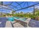 Relax in this pool and spa with screened-in enclosure, surrounded by lush landscaping and a brick patio at 8209 Redonda Loop, Lakewood Ranch, FL 34202