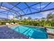 Enjoy the outdoors with this screened-in pool and spa, featuring lounge chairs and lush landscaping at 8209 Redonda Loop, Lakewood Ranch, FL 34202