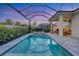 Stunning pool with screened-in enclosure, featuring a built-in spa and outdoor kitchen for the ultimate backyard experience at 8209 Redonda Loop, Lakewood Ranch, FL 34202