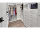 Organized walk-in closet featuring custom shelving, drawers, and hanging rods for efficient storage at 8209 Redonda Loop, Lakewood Ranch, FL 34202