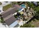 Drone shot of the home with its pool, patio, and colorful seating at 8709 9Th Nw Ave, Bradenton, FL 34209