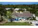 Aerial view of the home showcasing its charming exterior, lush landscaping, and inviting pool area at 8709 9Th Nw Ave, Bradenton, FL 34209