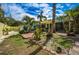 Beautiful backyard with tropical landscaping, a small patio, and a charming shed at 8709 9Th Nw Ave, Bradenton, FL 34209