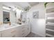 Bright bathroom featuring a double vanity, modern fixtures, decorative plants, and built-in shelving at 8709 9Th Nw Ave, Bradenton, FL 34209