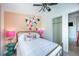 Comfortable bedroom featuring a queen-sized bed, flamingo decor and unique accent wall at 8709 9Th Nw Ave, Bradenton, FL 34209