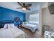 Shared bedroom with hardwood floors, two beds, and bright blue wall at 8709 9Th Nw Ave, Bradenton, FL 34209