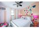 Bright bedroom features a flamingo themed decor, geometric accent wall and a queen-sized bed at 8709 9Th Nw Ave, Bradenton, FL 34209