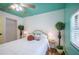 Bedroom with wooden floors, colorful walls, and bright natural lighting at 8709 9Th Nw Ave, Bradenton, FL 34209