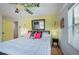 Bedroom with wooden floors, colorful wall, and large bed with tropical fan at 8709 9Th Nw Ave, Bradenton, FL 34209