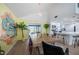 Bright dining area with breakfast bar seating, colorful accent wall, and modern light fixture at 8709 9Th Nw Ave, Bradenton, FL 34209